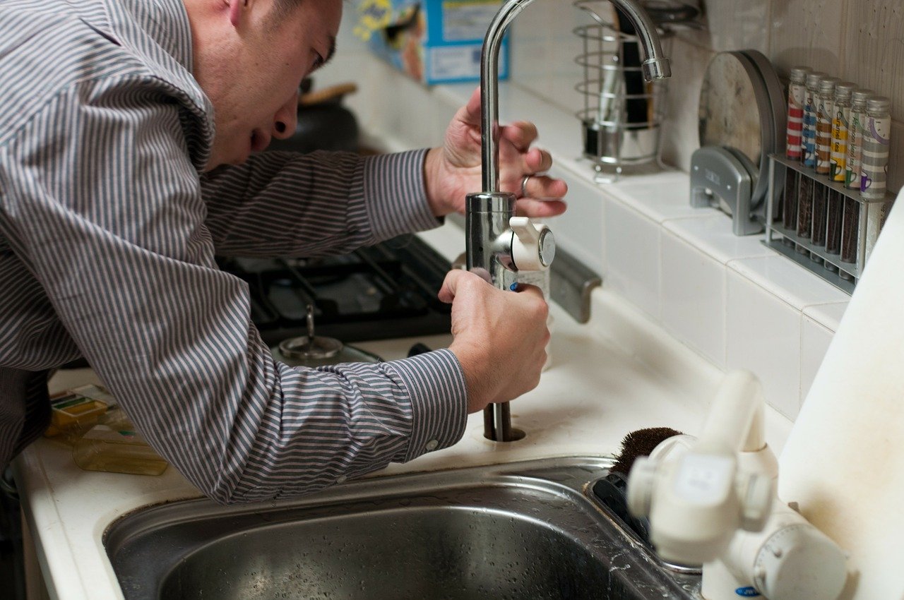 man fixing plumbing problem